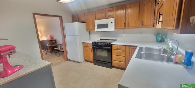 kitchen featuring white appliances, light countertops, brown cabinets, and a sink