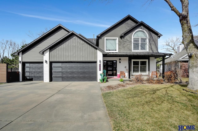 view of front of home featuring a front lawn, driveway, covered porch, an attached garage, and brick siding