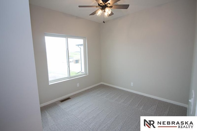 unfurnished room with visible vents, ceiling fan, baseboards, and carpet