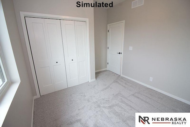 unfurnished bedroom with carpet flooring, baseboards, visible vents, and a closet