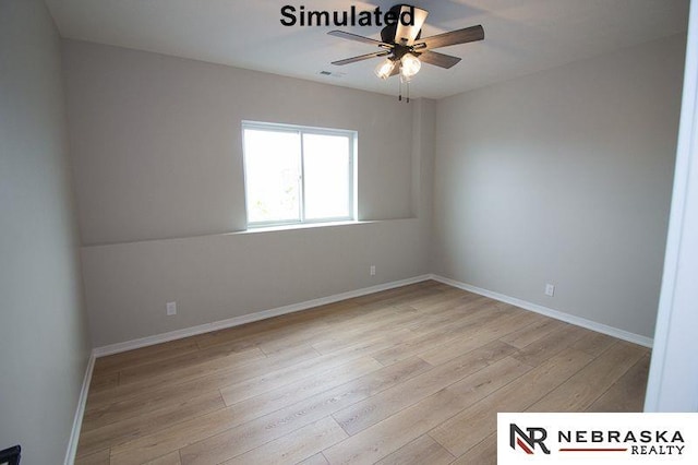 spare room featuring baseboards, light wood-style flooring, and a ceiling fan