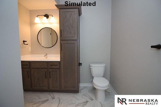 half bathroom with vanity, toilet, baseboards, and marble finish floor