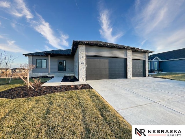 ranch-style home with a garage, concrete driveway, and a front yard