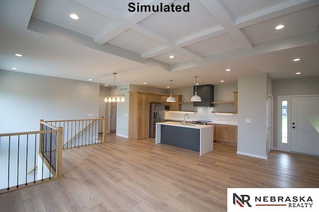 kitchen featuring light wood finished floors, coffered ceiling, brown cabinets, and freestanding refrigerator