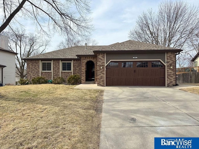 ranch-style home featuring brick siding, concrete driveway, a garage, and a front yard