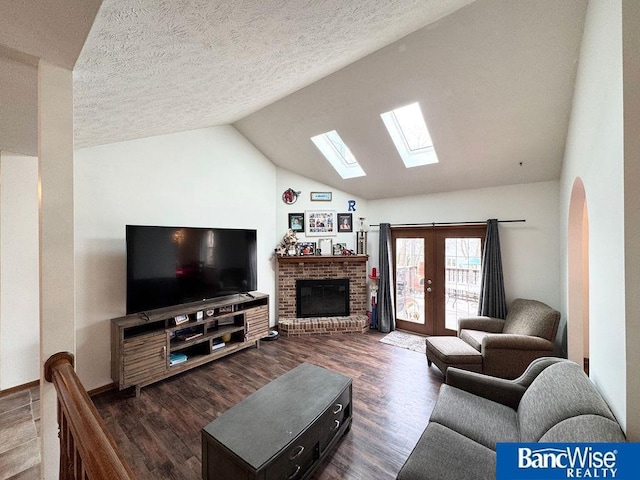 living area with lofted ceiling, french doors, dark wood-type flooring, and a textured ceiling