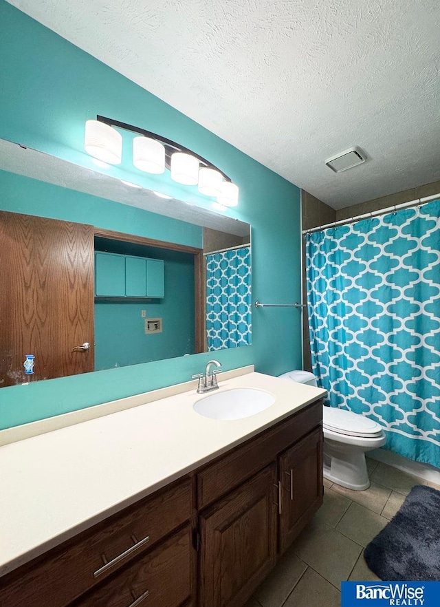 full bathroom with tile patterned flooring, toilet, a textured ceiling, and vanity