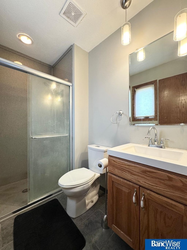 bathroom featuring vanity, visible vents, a shower stall, tile patterned floors, and toilet