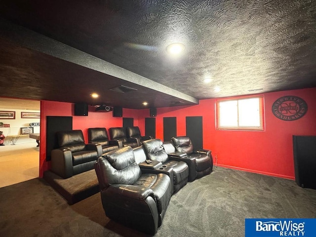 home theater room featuring a textured ceiling and carpet