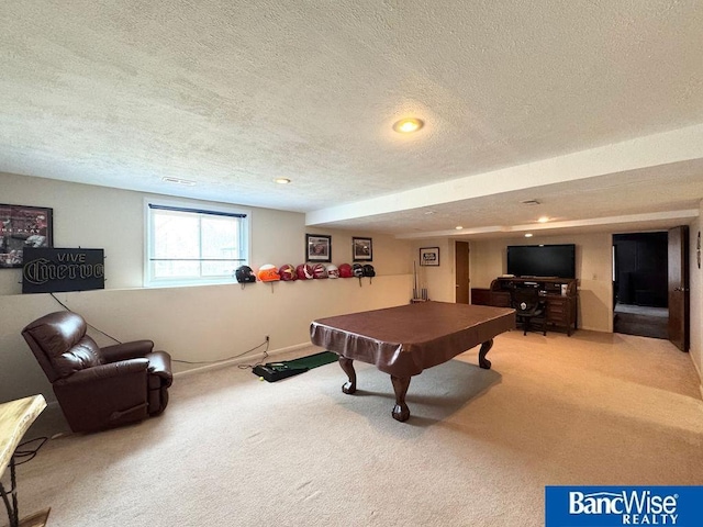 recreation room with carpet flooring, pool table, and a textured ceiling