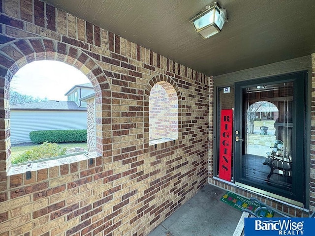 property entrance featuring brick siding