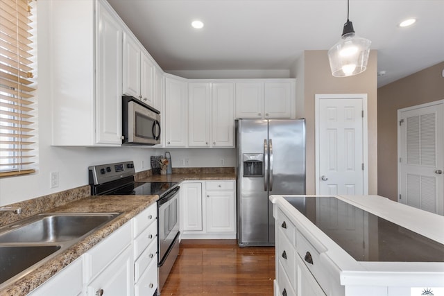 kitchen featuring a sink, stainless steel appliances, white cabinets, and dark wood-style flooring