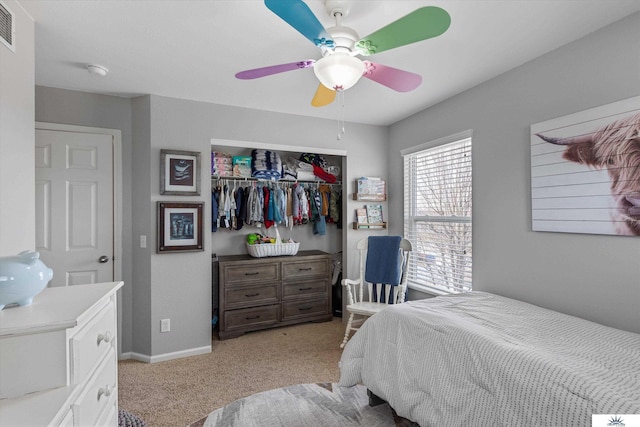 bedroom featuring a ceiling fan, baseboards, visible vents, a closet, and light carpet