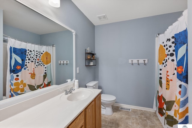 bathroom with visible vents, toilet, vanity, and baseboards