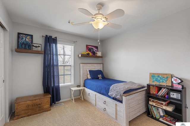 bedroom featuring visible vents, a ceiling fan, and carpet