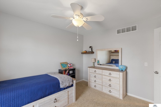 bedroom featuring a ceiling fan, light colored carpet, visible vents, and baseboards