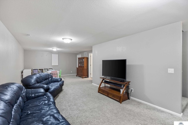 living area with a textured ceiling, baseboards, and carpet floors