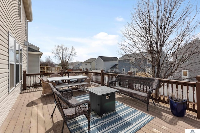 wooden deck featuring a residential view and outdoor dining space