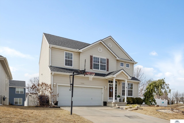 traditional-style home featuring concrete driveway, an attached garage, and a shingled roof