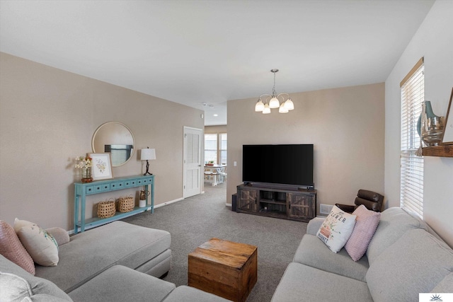 carpeted living area featuring an inviting chandelier and baseboards