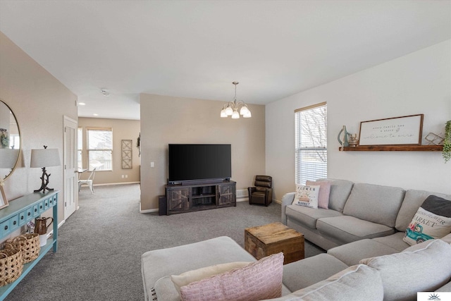 living room with baseboards, carpet, and a chandelier