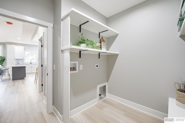 laundry room with baseboards, light wood-type flooring, laundry area, hookup for a washing machine, and hookup for an electric dryer