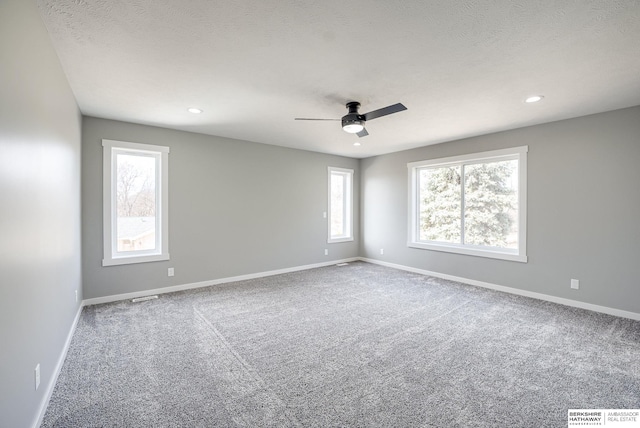 carpeted empty room featuring recessed lighting, visible vents, and baseboards