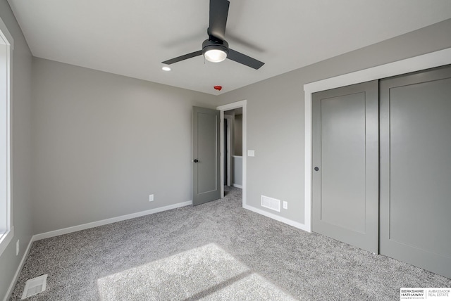 unfurnished bedroom with a closet, visible vents, baseboards, and carpet floors