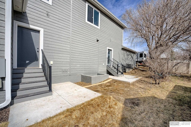 back of house featuring entry steps