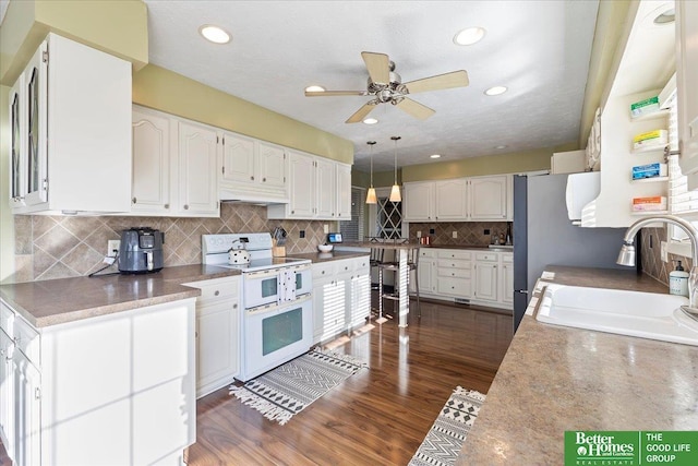 kitchen with white cabinetry, double oven range, dark wood-style flooring, and a sink