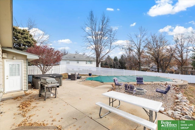 view of pool with a fenced backyard, a fenced in pool, a hot tub, and a patio