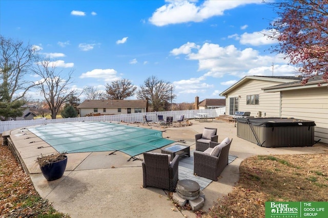 view of pool featuring a patio area, a fenced in pool, a hot tub, and fence