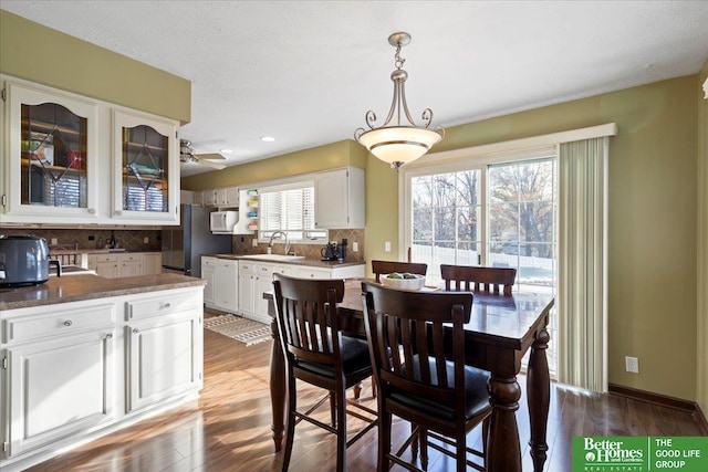 dining room with ceiling fan, baseboards, wood finished floors, and recessed lighting