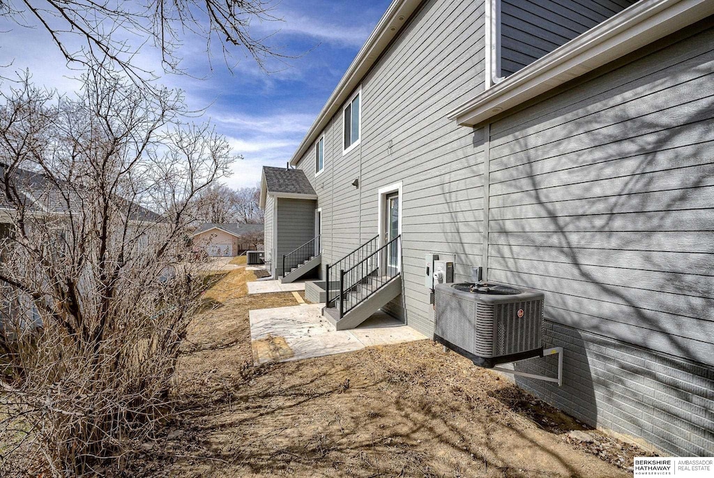 view of property exterior featuring entry steps and central AC unit