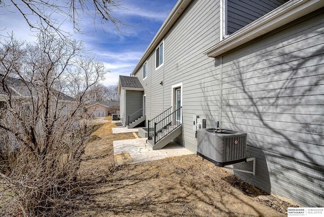 view of property exterior featuring entry steps and central AC unit