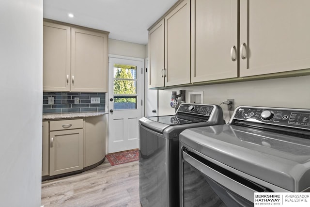 laundry room with washer and dryer, cabinet space, light wood-style flooring, and recessed lighting