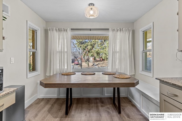 dining area with breakfast area, visible vents, light wood-style floors, and a wealth of natural light