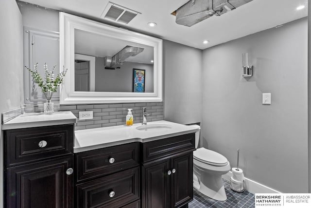 bathroom featuring visible vents, backsplash, toilet, recessed lighting, and vanity