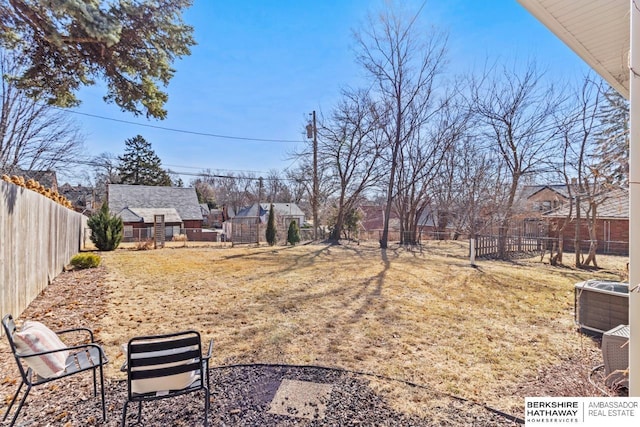 view of yard with cooling unit and a fenced backyard