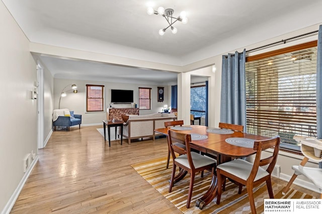 dining room featuring visible vents, baseboards, and light wood finished floors