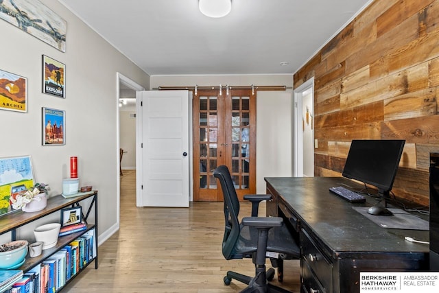 office area featuring wooden walls, baseboards, and wood finished floors