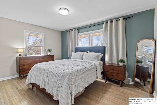 bedroom featuring baseboards and hardwood / wood-style flooring