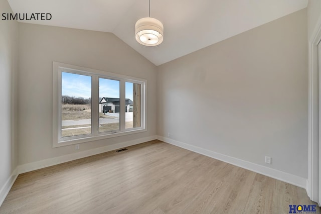 unfurnished room featuring visible vents, lofted ceiling, baseboards, and light wood-style flooring