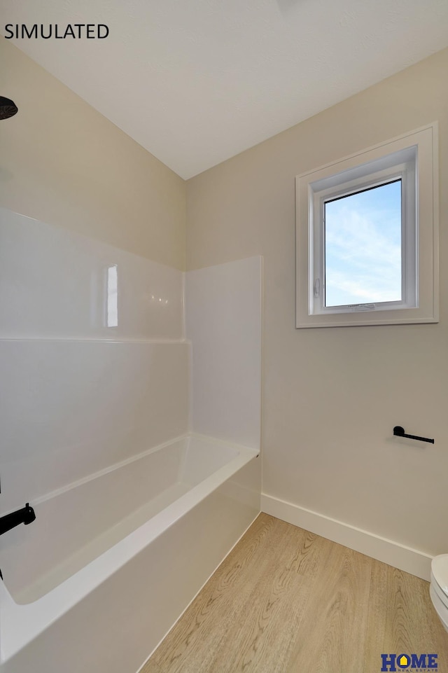 full bathroom featuring shower / bath combination, baseboards, toilet, and wood finished floors