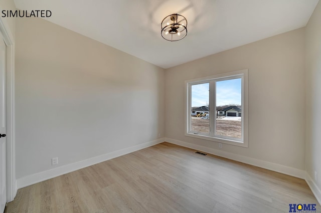 unfurnished room with visible vents, baseboards, and light wood finished floors