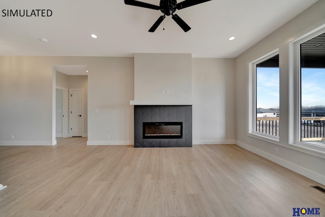 unfurnished living room featuring recessed lighting, a fireplace, light wood-type flooring, and baseboards