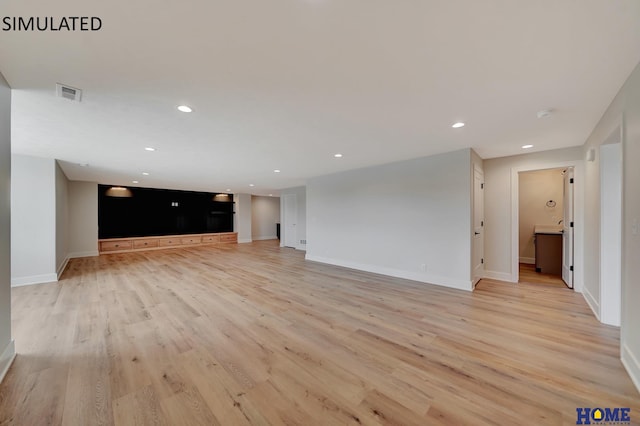 unfurnished living room with visible vents, recessed lighting, baseboards, and light wood-style floors