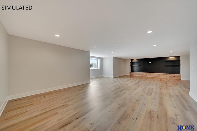 unfurnished living room featuring recessed lighting, baseboards, and light wood-style floors