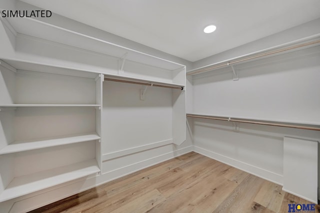 walk in closet featuring wood finished floors