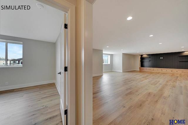 below grade area with recessed lighting, baseboards, and light wood finished floors